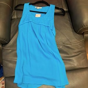 Vibrant blue tank top with lace on the top. Can be used for casual or business